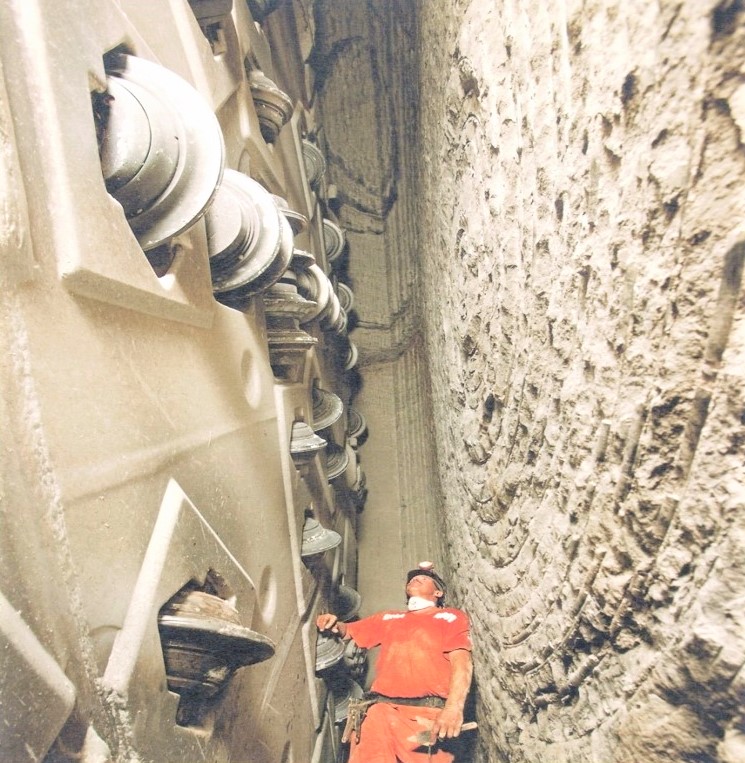 WORKER INSIDE MAINTENANCE BLOCK INSPECTING TBM CUTTING HEAD